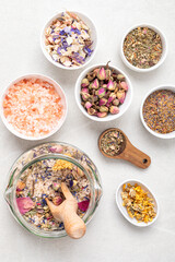 Botanical blends, salt, herbs, essencial oils for naturopathy. Natural remedy, herbal medicine, blends for bath and tea on wooden table background