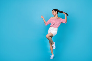 Fototapeta na wymiar Full length photo of sweet funky girl dressed off shoulders striped blouse dancing having fun empty space isolated blue color background