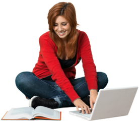 Caucasian female sitting cross legged with a textbook and laptop open in front of her