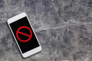 Crossed out red sign on phone screen.