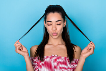 Portrait of funky lady pouty lips kiss plump playing brunette hair ponytails wear red top close eyes isolated on blue color background
