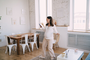 Pregnant woman listening to music on smartphone