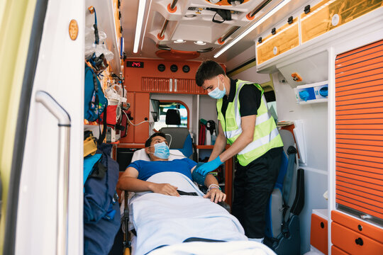 Ambulance worker taking care of patient in vehicle