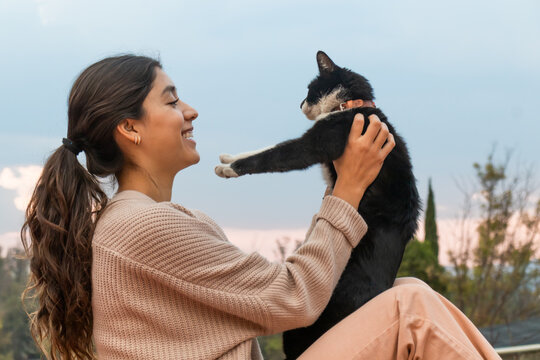 Happy woman with cute stray cat