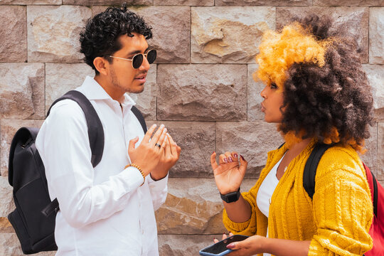 Multiethnic friends by stone wall