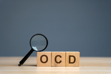 Wooden blocks with the abbreviation OCD. Obsessive compulsive disease. Mental health and psychiatry...