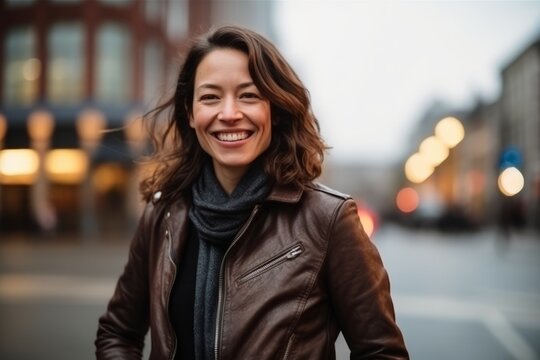 Portrait Of A Happy Young Woman In A City Street At Dusk