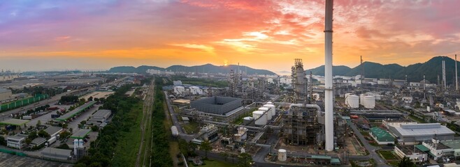 Crude Oil Refinery Plant Steel Pipe line and Chimney and Cooling tower, Chemical or Petrochemical factory plant power plant, Petrochemical tower tank industry at sunset