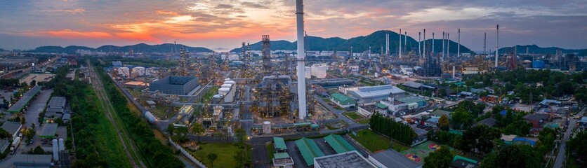 Crude Oil Refinery Plant Steel Pipe line and Chimney and Cooling tower, Chemical or Petrochemical factory plant power plant, Petrochemical tower tank industry at sunset