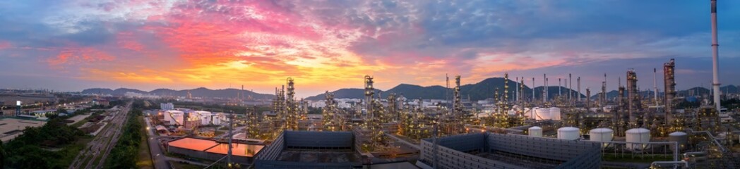 Fototapeta na wymiar Crude Oil Refinery Plant Steel Pipe line and Chimney and Cooling tower, Chemical or Petrochemical factory plant power plant, Petrochemical tower tank industry at sunset