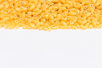 Uncooked Chifferi Rigati Pasta Scattered on White Table. Fat and Unhealthy Food. Classic Dry Macaroni. Italian Culture and Cuisine. Raw Pasta