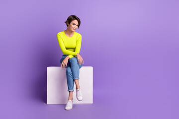 Full length body photo of nice model young age woman sitting podium posing for magazine brand store isolated on violet color background