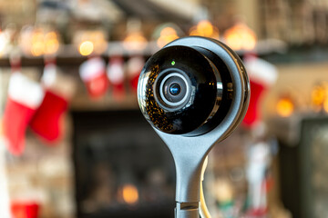 An active security camera with the light on in front of an interior living room of a home at...