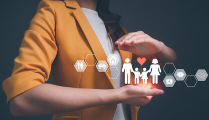 Hands with protective gesture around cutout paper of family. protecting family, insurance, domestic violence, world mental health day, international day of families, family day, family care concept.