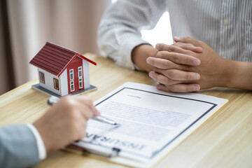 Fototapeta na wymiar Business people signing contract making deal with real estate agent Concept for consultant home insurance.Real estate investment Property insurance security. Real estate agent offer house