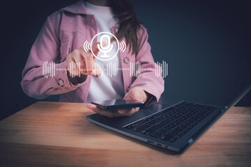 Woman hand touch the microphone button voice assistant on smartphone, talking to smartphone for...