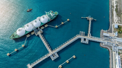 LNG (Liquified Natural Gas) tanker anchored in Gas terminal gas tanks for storage. Oil Crude Gas Tanker Ship. LPG at Tanker Bay Petroleum Chemical or Methane freighter export import transportation 