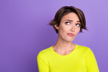 Photo of pretty minded girl look interested empty space contemplate hesitate isolated on violet...