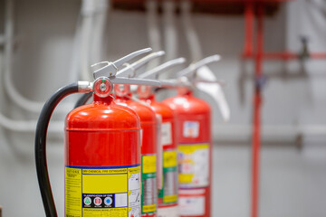 The red fire extinguisher is in the building for fire prevention and safety.