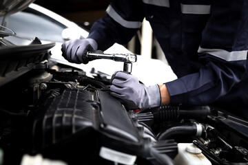 Auto mechanic working on car engine in mechanics garage.Repair service,car service, repair, maintenance concept.