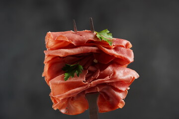 Skewed with a bbq fork dried beef meat with herbs and spicy