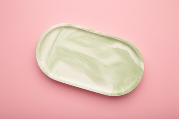 Mint plaster trays on pink background. Stands for candles or jewelry
