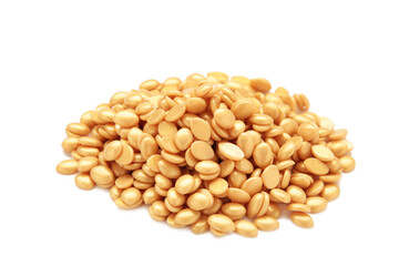 Beige wax for depilation isolated on white background.Wax granules for depilation. Epilation, depilation, removal of unwanted hair.