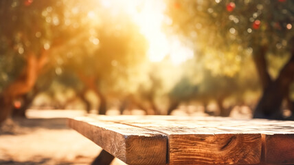 Empty wooden table top, texture board, on a blurred background of an orchard, trees in blurred bokeh