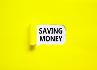 Saving money symbol. Concept words Saving money on beautiful white paper on a beautiful yellow background. Business, support and saving money concept. Copy space.