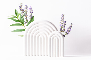 Beautiful composition with white geometric podiums for cosmetic exhibition and fresh aromatic...