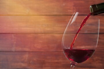 pouring tasty alcohol red wine in the glass.