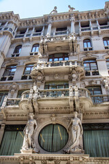 Ornate historic building facade with balconies in Italy © Miros