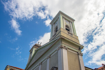 Light colored church bell tower and classical facade in Italy © Miros