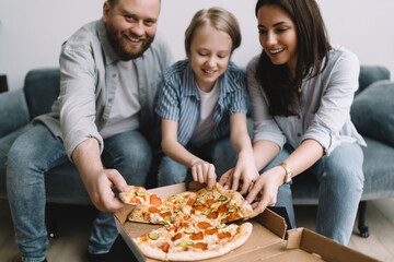 Smiling family eating tasty pizza on sofa