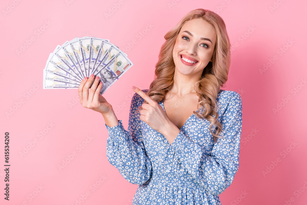 Sticker photo of lovely cute positive girl toothy smile indicate finger hand hold dollar banknotes bills iso