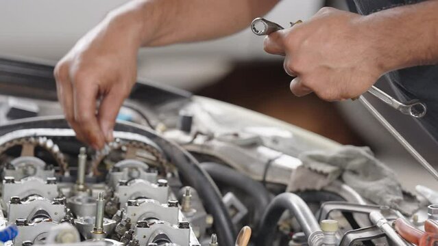 Auto mechanic repair engine in a car repair shop.Car engine repair. Car service