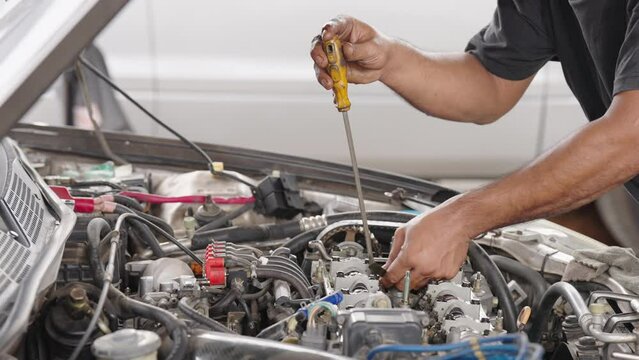 Auto mechanic repair engine in a car repair shop.Car engine repair. Car service