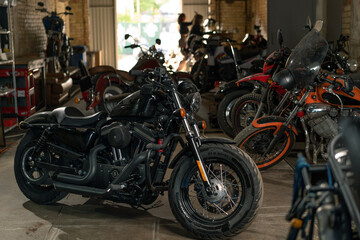 Fototapeta na wymiar Creative authentic motorcycle workshop many different motorcycles are standing in the garage