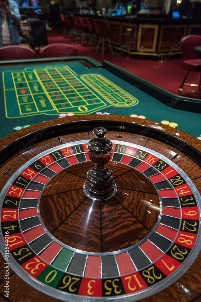 Wall mural casino, gambling and entertainment concept - roulette table and stack of poker chips