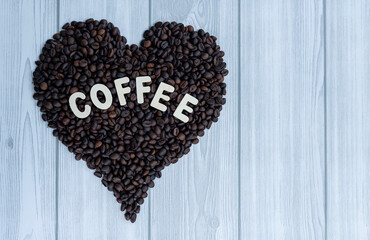Coffee beans in shape of heart isolated on white wooden texture background, Coffee lover concept image