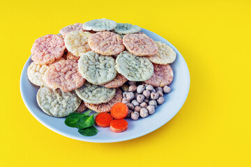 Chickpea chips snack with vegetables on a yellow background