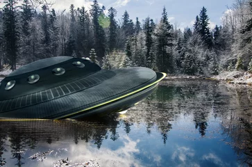 Poster UFO, broken space saucer lies in the water on the banks of a river or lake after an accident and crash. Landscape with invasion by extraterrestrial space object © TSViPhoto