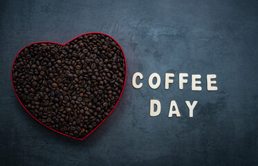 International coffee day image, fresh coffee beans in a heart shape box isolated on grey colour background