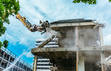 Demolition of the old building. residential house, building at construction site against blue...