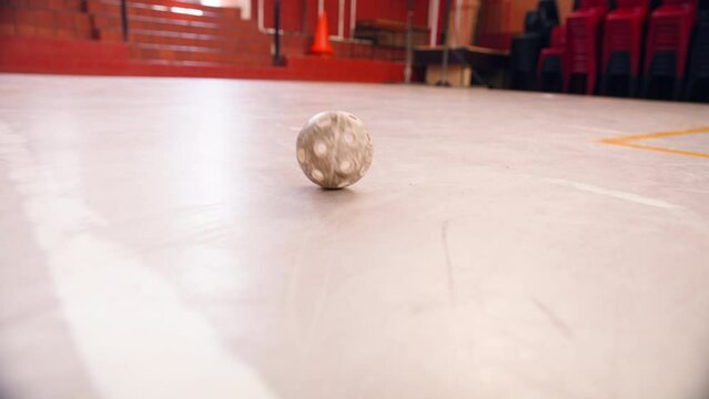 A floorball rolling inside a sport venue