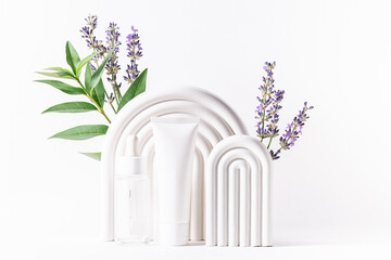 Organic herbal cosmetic products with lavender extract on white background with geometric clay decorations and lavender flowers close up. Natural cosmetic concept.