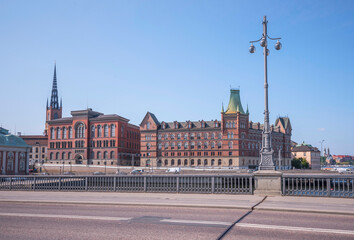 Obraz premium View from the bridge Vasabron with lamppost, office stone houses on the island Riddarholmen, a sunny summer day in Stockholm