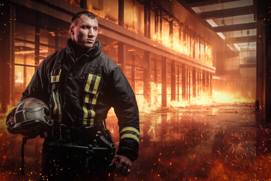 Confident and brave firefighter holding a protective helmet amidst a raging inferno inside an office building. The image evokes a strong sense of courage and determination