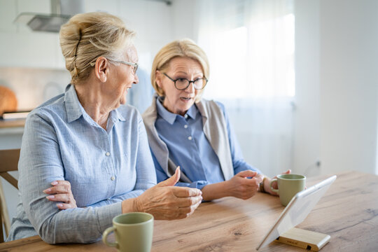 senior mature women family or friends use digital tablet video call