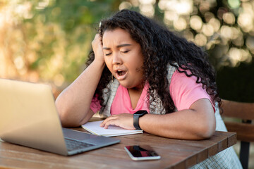 Bored Hispanic Student Lady Yawning Sitting At Laptop Outdoors